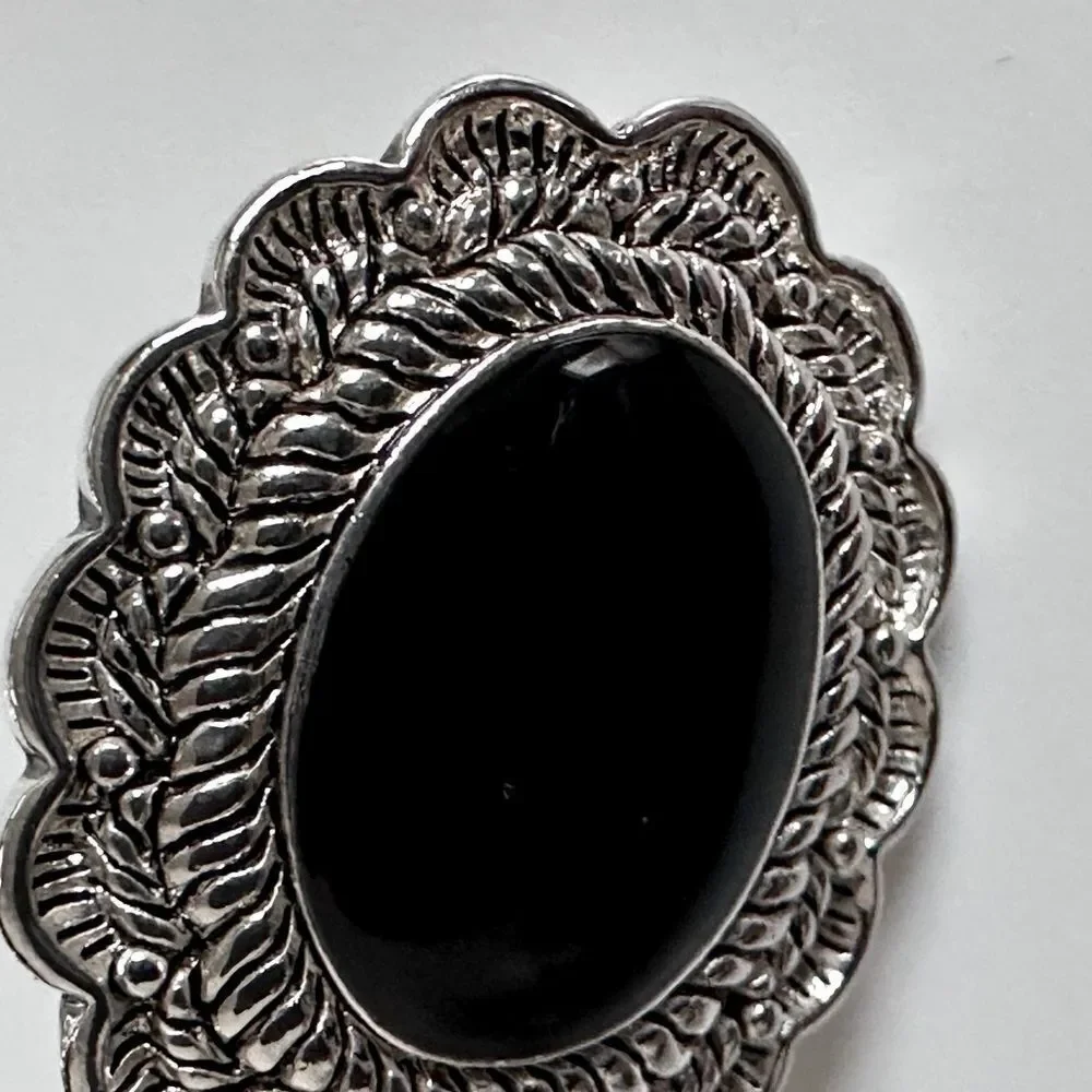 Vintage Sterling Silver Oval Clip-On Earrings with a black stone.